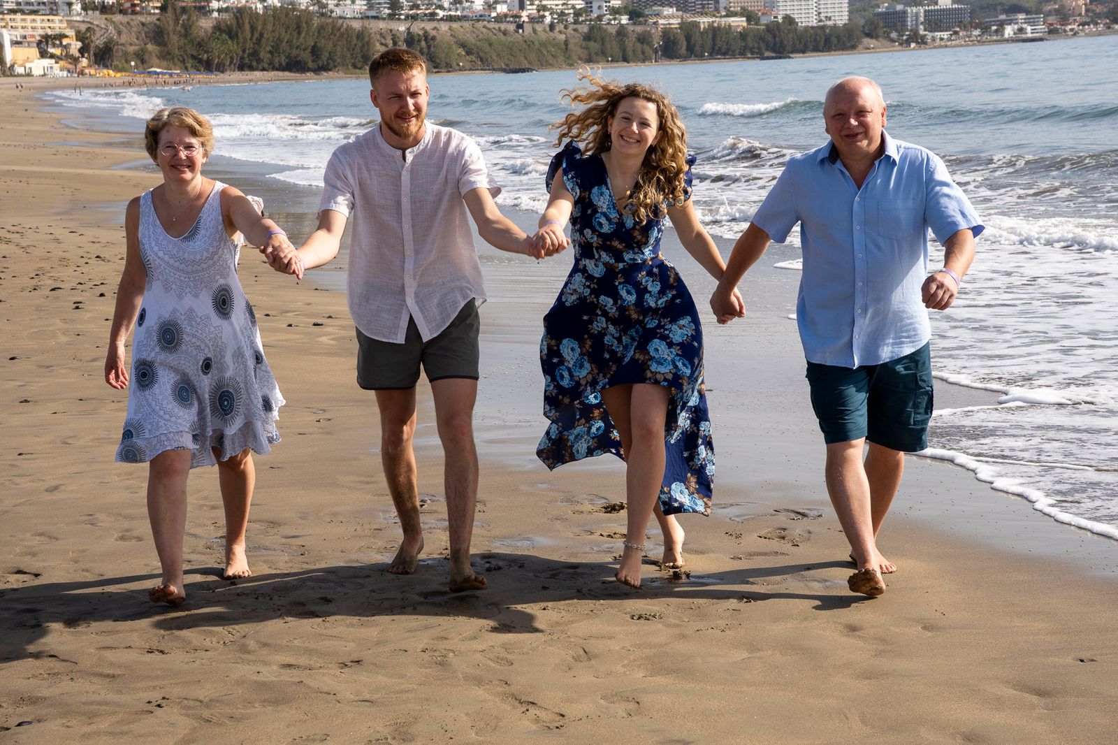 Family of four running on the beach Gran Canaria